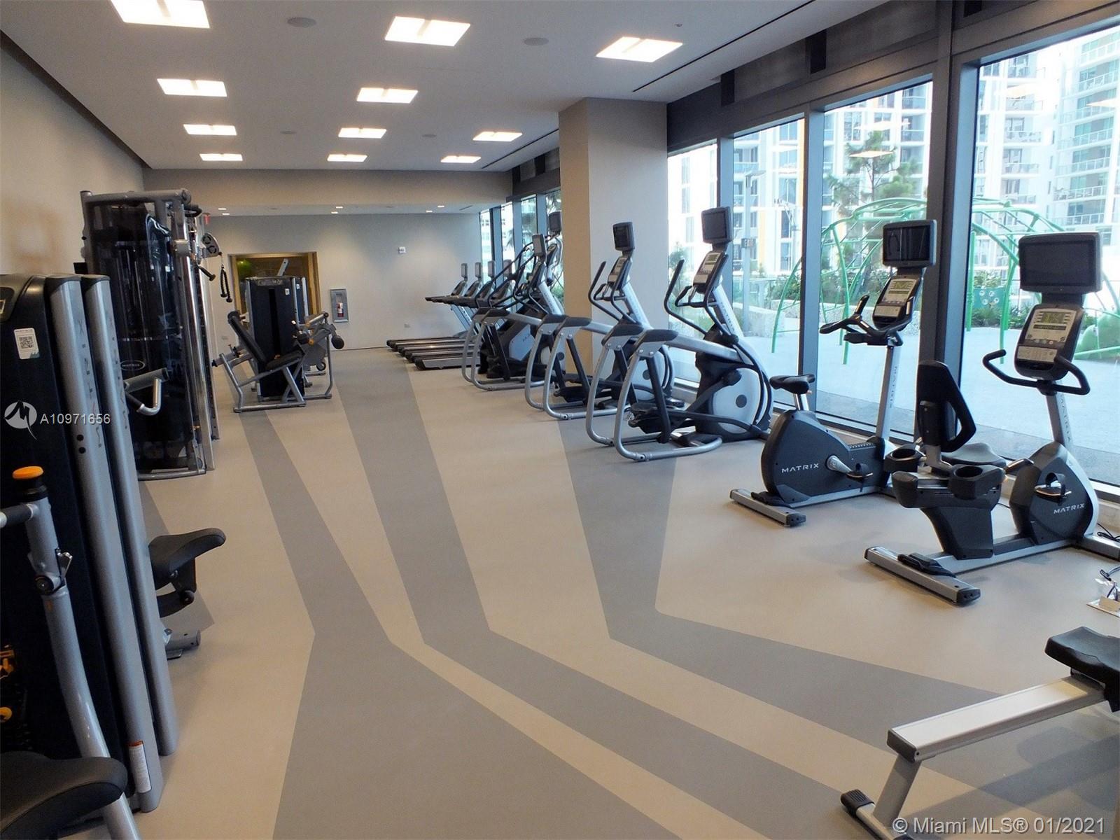 68 Southeast 6th Street, Unit 1010 Miami, FL 33131 - Photo 26 of 43 a view of a room with gym equipment