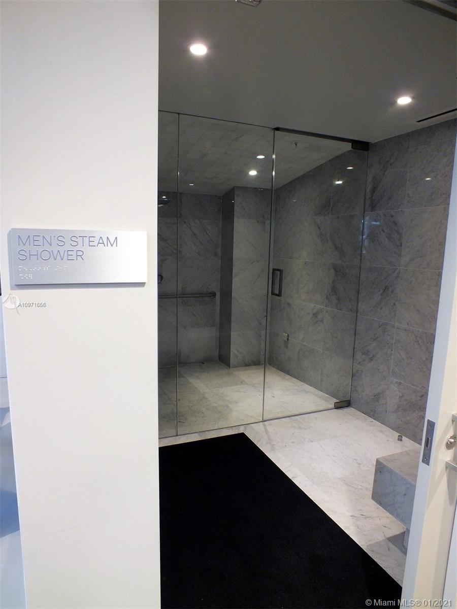 68 Southeast 6th Street, Unit 1010 Miami, FL 33131 - Photo 27 of 43 a bathroom with a shower and a sink