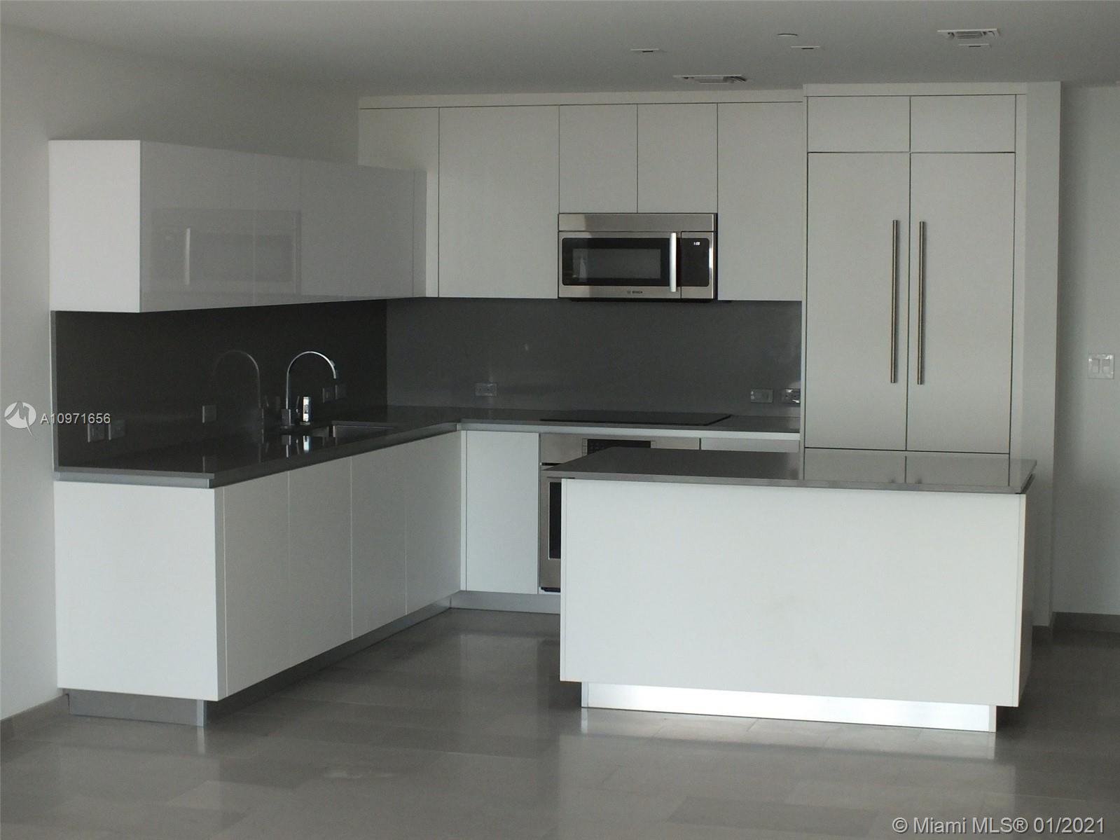68 Southeast 6th Street, Unit 1010 Miami, FL 33131 - Photo 5 of 43 a view of a kitchen with an oven