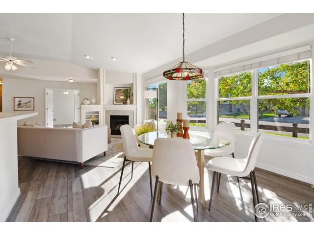 a dining room with furniture a chandelier and wooden floor