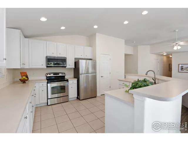 a kitchen with kitchen island a sink stainless steel appliances and counter space