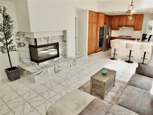 a kitchen with kitchen island a stove a sink and a refrigerator with wooden cabinets