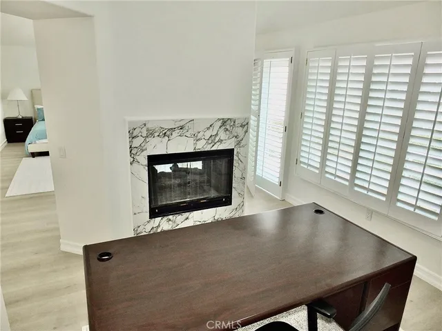 a view of a lake with a yard and a large tree