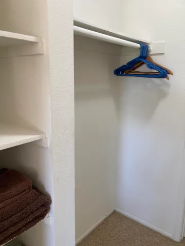 a kitchen with stainless steel appliances a microwave a stove a sink cabinets and a dining table