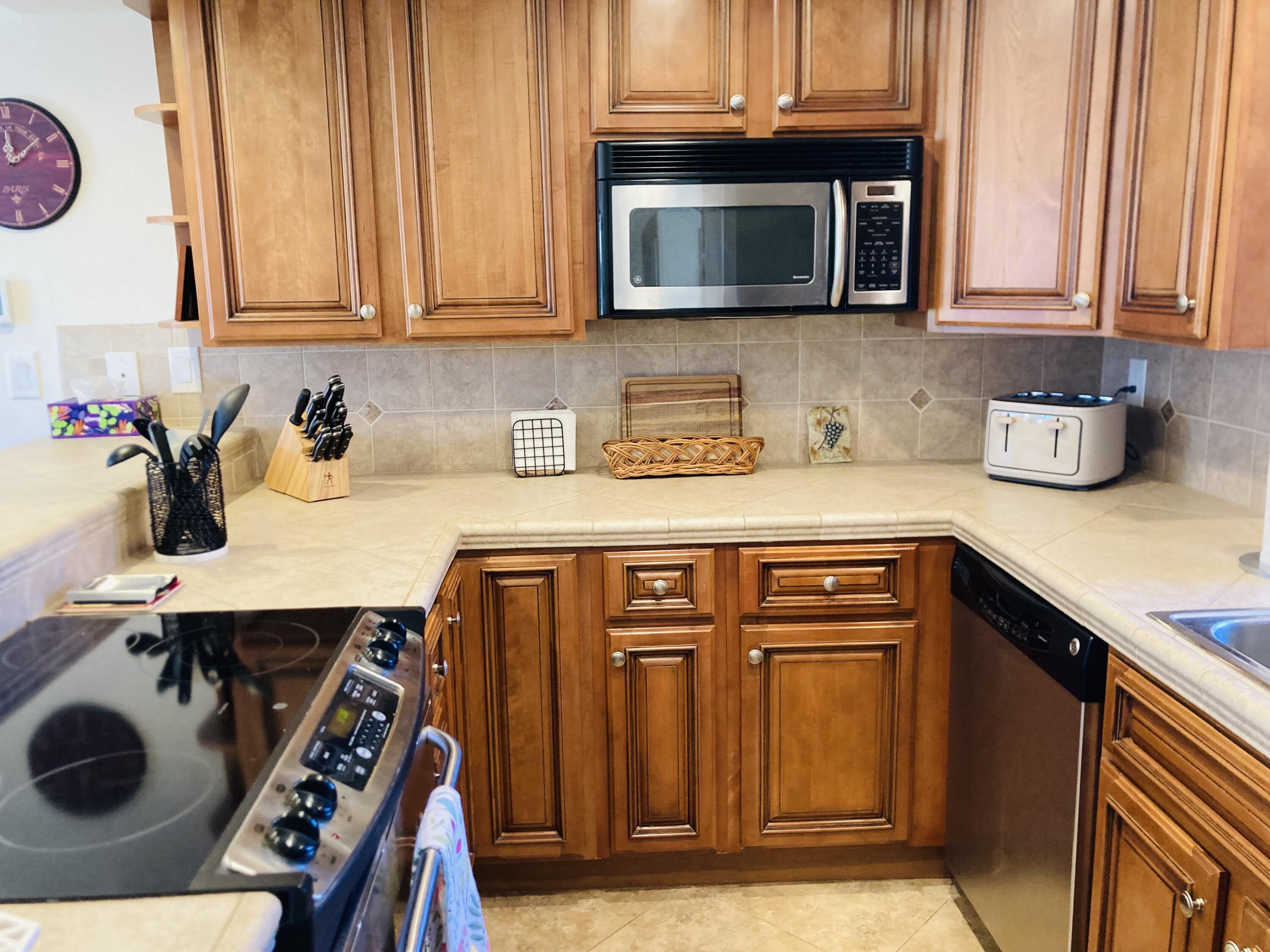 40553 Pebble Beach Circle Palm Desert, CA 92211 - Photo 21 of 22 a kitchen with a sink a microwave and cabinets