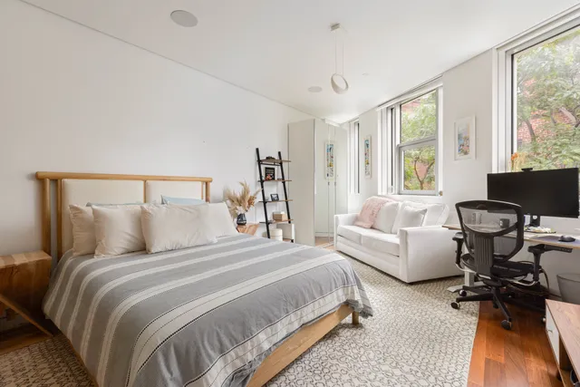 a bedroom with a bed and a couch