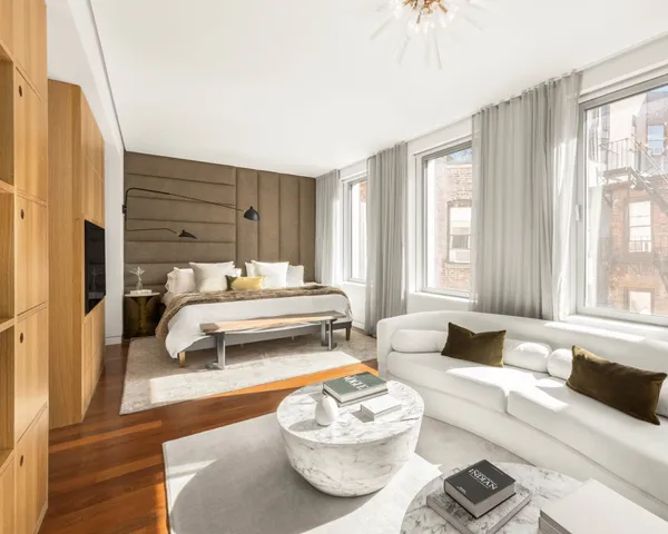 a bedroom with a bed and a couch