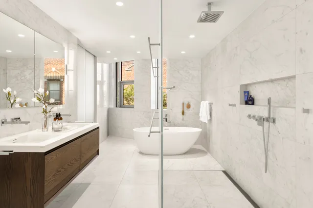 a large bathroom with a double vanity sink mirror and bathtub