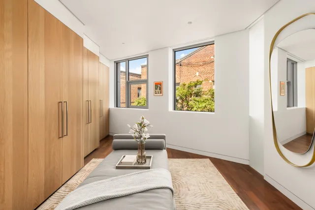 a bedroom with furniture and a window