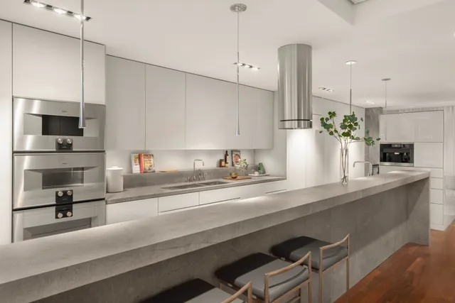 a kitchen with kitchen island a sink appliances and cabinets