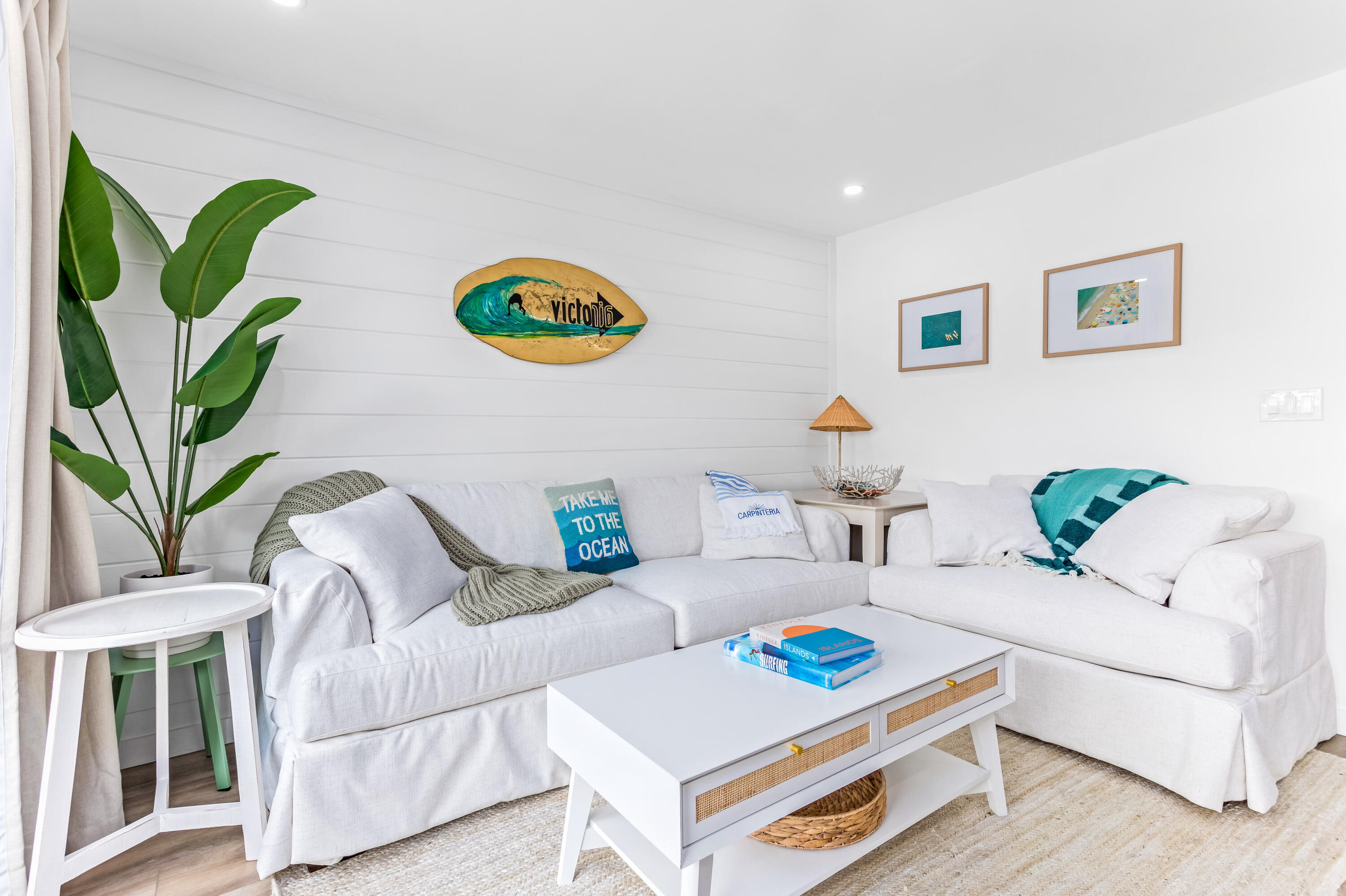 a living room with furniture and a potted plant