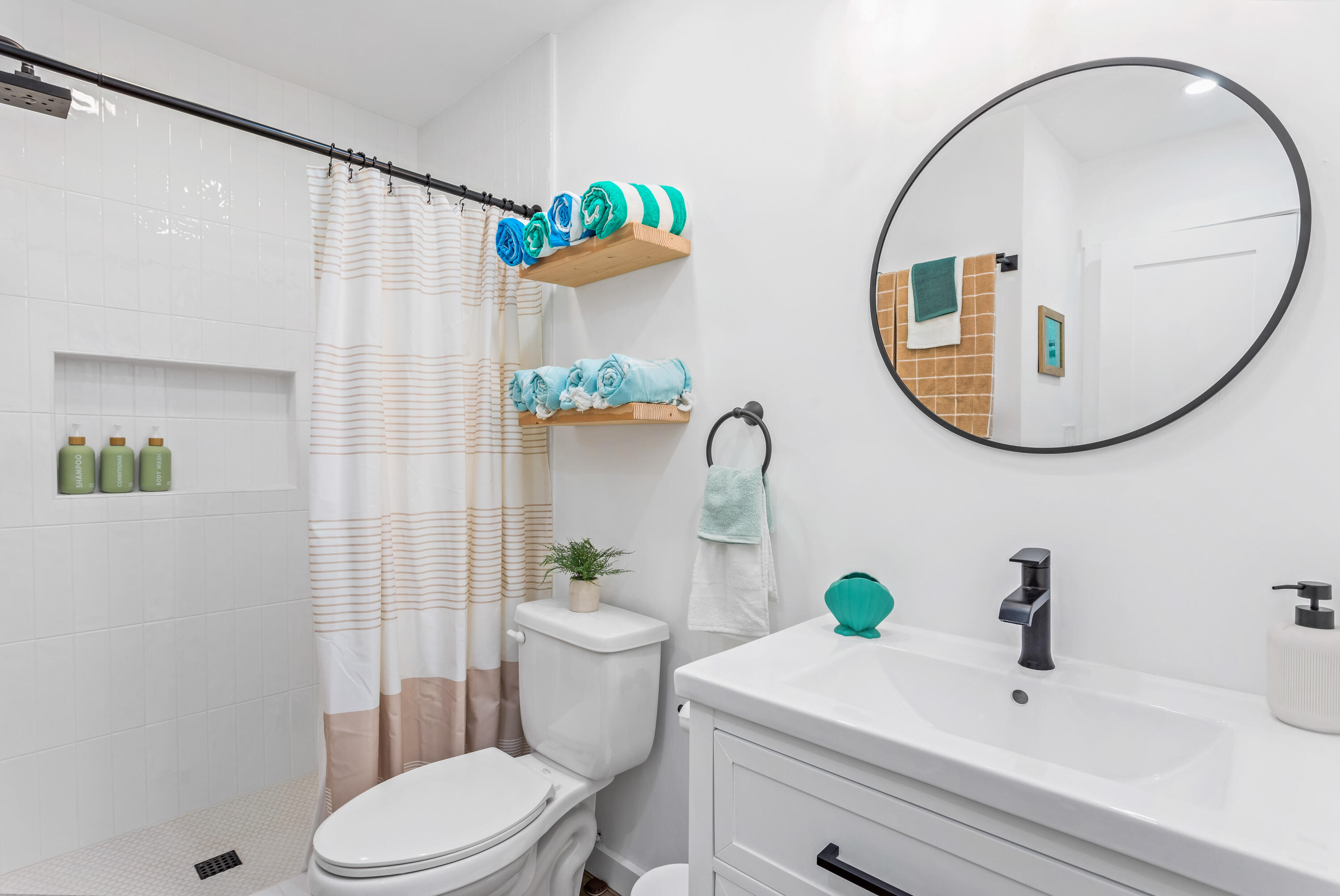 4902 Sandyland Road, Unit 134 Carpinteria, CA 93013 - Photo 8 of 19 a bathroom with a sink mirror and toilet