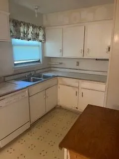 a kitchen with a sink and cabinets