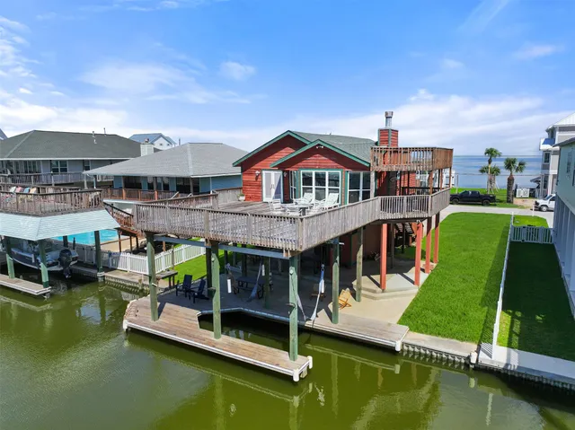 a view of a house with pool and chairs