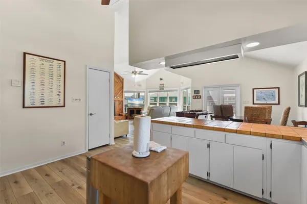 a open kitchen with white cabinets and sink