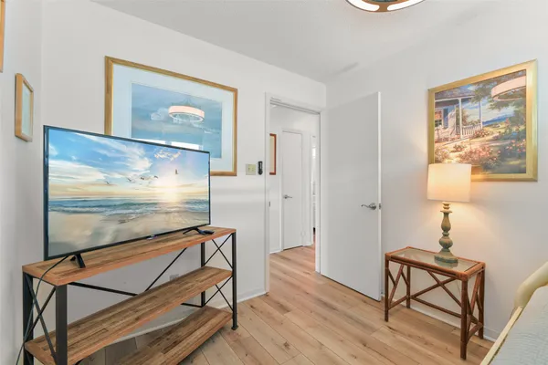 a room with wooden floor pool table and windows
