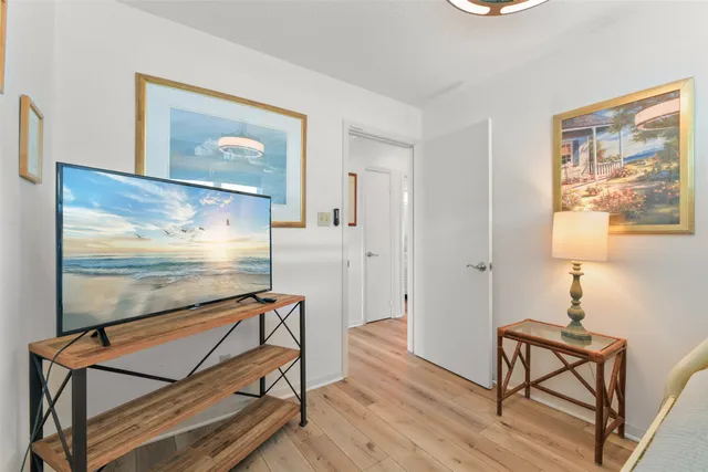 a room with wooden floor pool table and windows