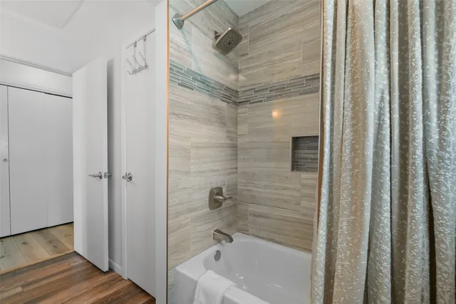 a bathroom with a bathtub and a shower