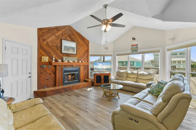 a living room with furniture a fireplace and a large window