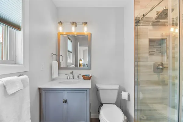 a bathroom with a toilet sink and shower