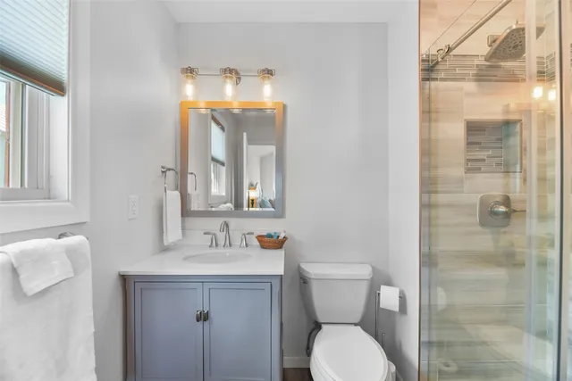 a bathroom with a toilet sink and shower