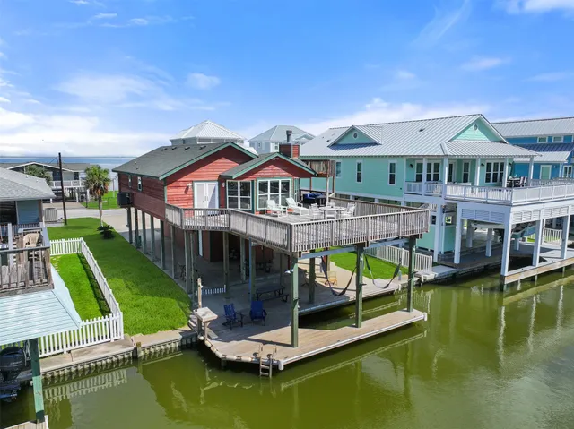 an aerial view of a house with swimming pool having outdoor seating
