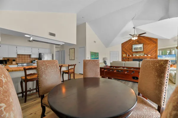 a living room with furniture and a dining table