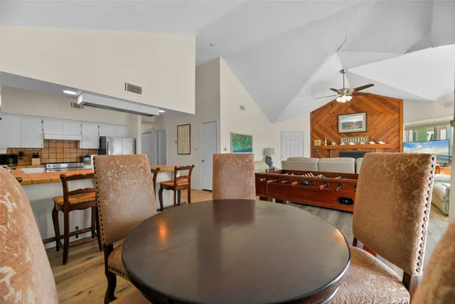 a living room with furniture and a dining table