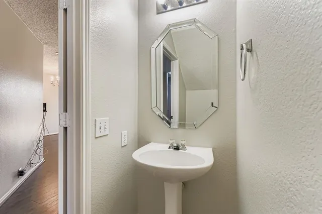 a bathroom with a sink a mirror and shower