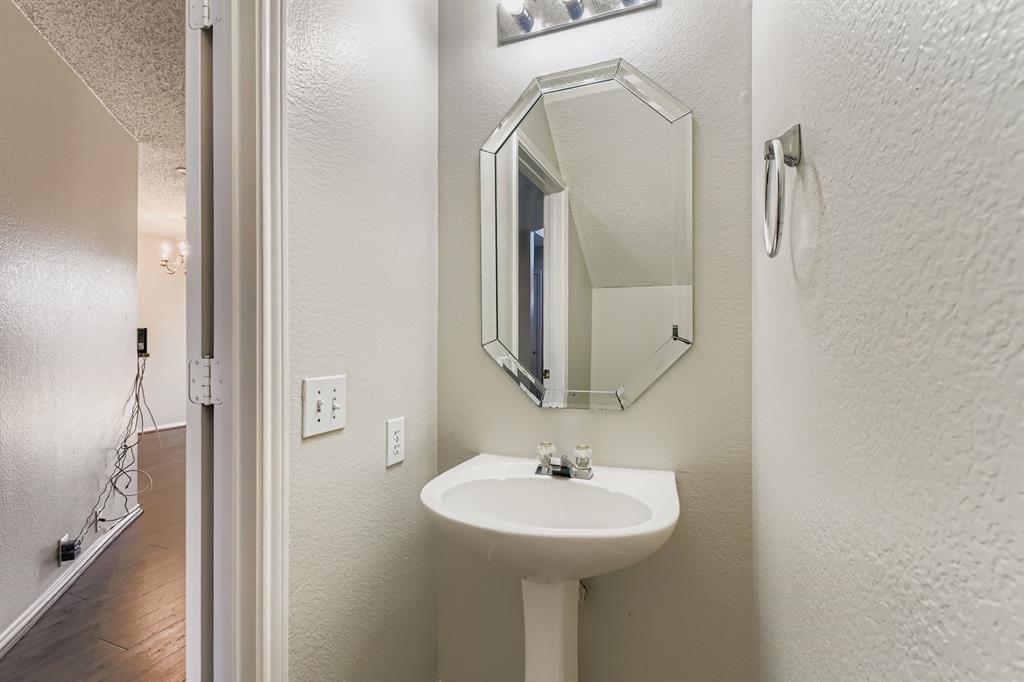 8532 Tallahassee Lane Fort Worth, TX 76123 - Photo 15 of 29 a bathroom with a sink a mirror and shower