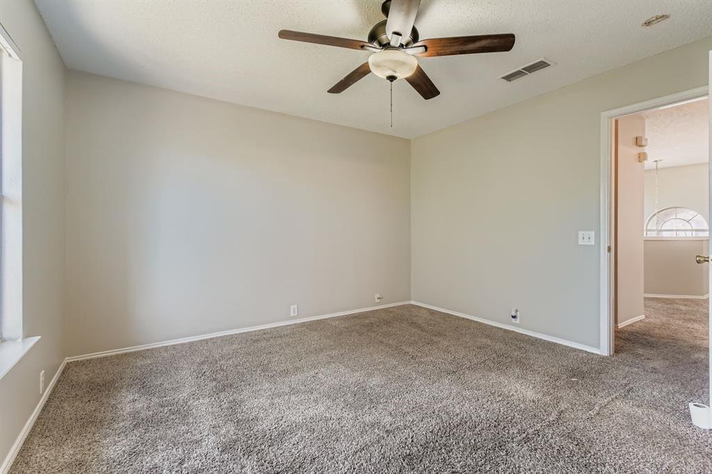 8532 Tallahassee Lane Fort Worth, TX 76123 - Photo 18 of 29 an empty room with a fan and a fan