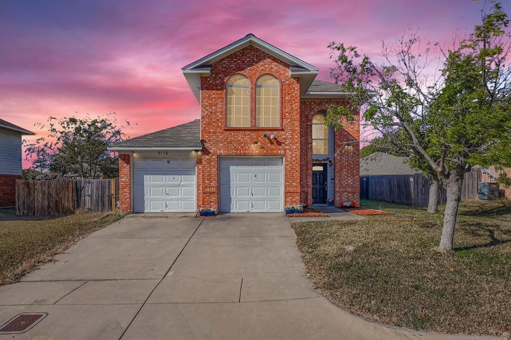 8532 Tallahassee Lane Fort Worth, TX 76123 - Photo 2 of 29 a front view of a house with a yard and garage
