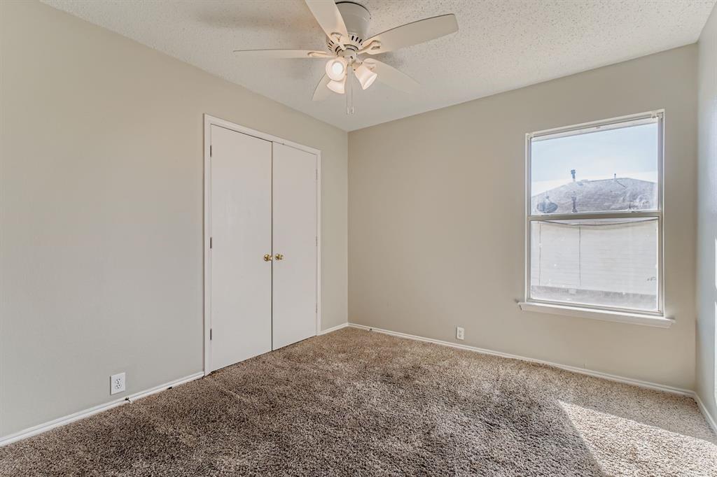8532 Tallahassee Lane Fort Worth, TX 76123 - Photo 21 of 29 an empty room with windows and closet
