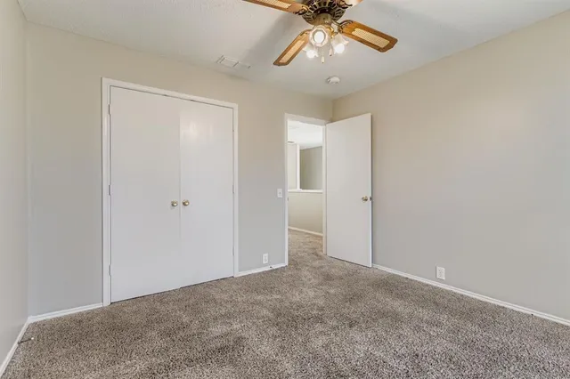 an empty room with a empty space and a ceiling fan