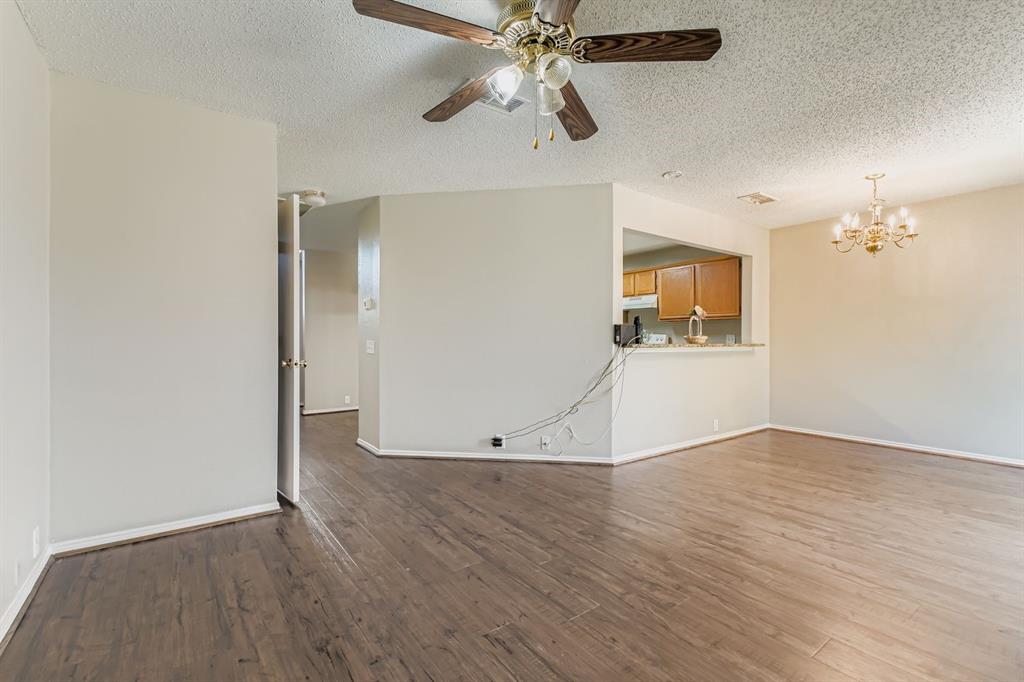 8532 Tallahassee Lane Fort Worth, TX 76123 - Photo 7 of 29 wooden floor in an empty room with a window