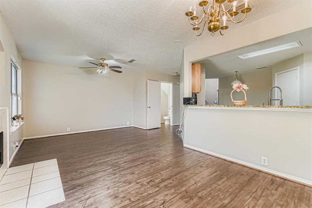 8532 Tallahassee Lane Fort Worth, TX 76123 - Photo 10 of 29 a view of a living room a chandelier and wooden floor