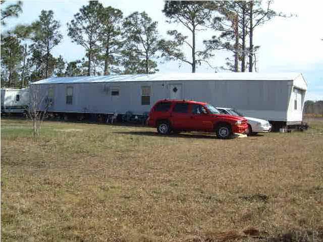 6415 Mary Kitchens Road Milton, FL 32583 - Photo 2 of 6 Full frontal view of 1988, 16x76, three bedroom/2 bath mobile home.