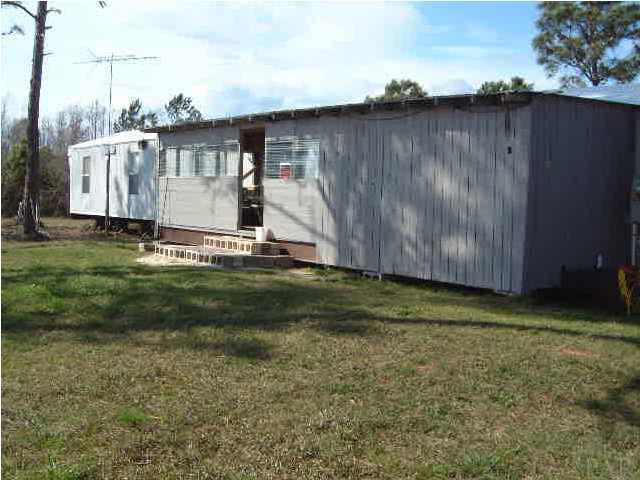 6415 Mary Kitchens Road Milton, FL 32583 - Photo 3 of 6 Back of enclosed porch to mobile home.