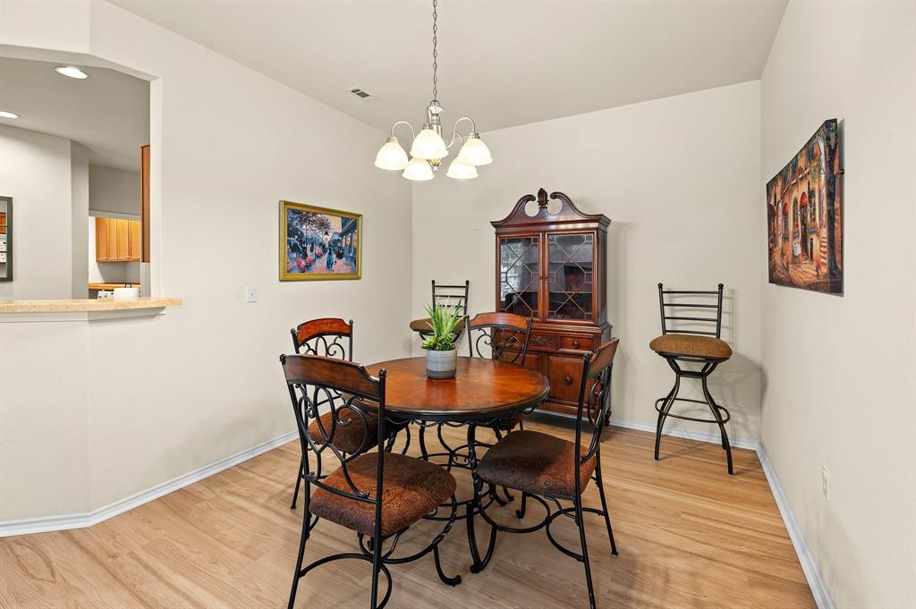 109 Providence Street Georgetown, TX 78633 - Photo 12 of 31 Dedicated dining area featuring wood-finish flooring and a contemporary chandelier