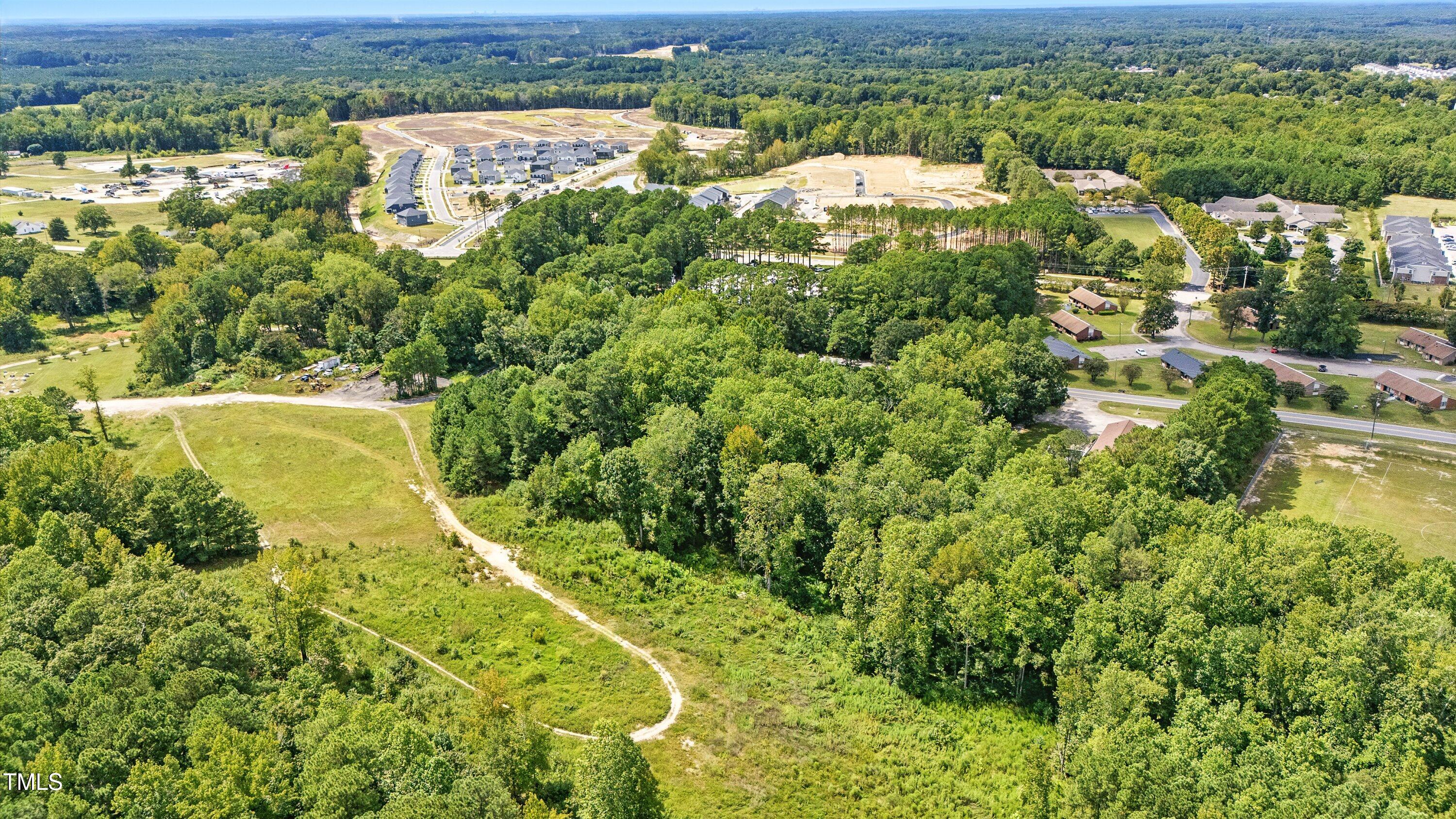 901 Mack-Todd Road Zebulon, NC 27597 - Photo 6 of 11 an aerial view of residential houses with outdoor space and trees