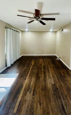 a view of a room with wooden floor