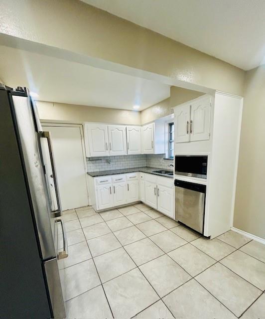 527 Aspen Street Lancaster, TX 75134 - Photo 5 of 18 a kitchen with white cabinets and white appliances