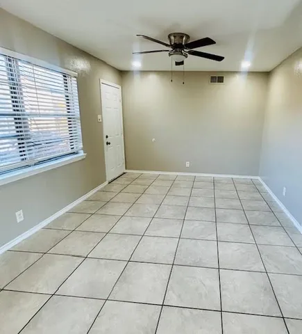 a view of an empty room and a window