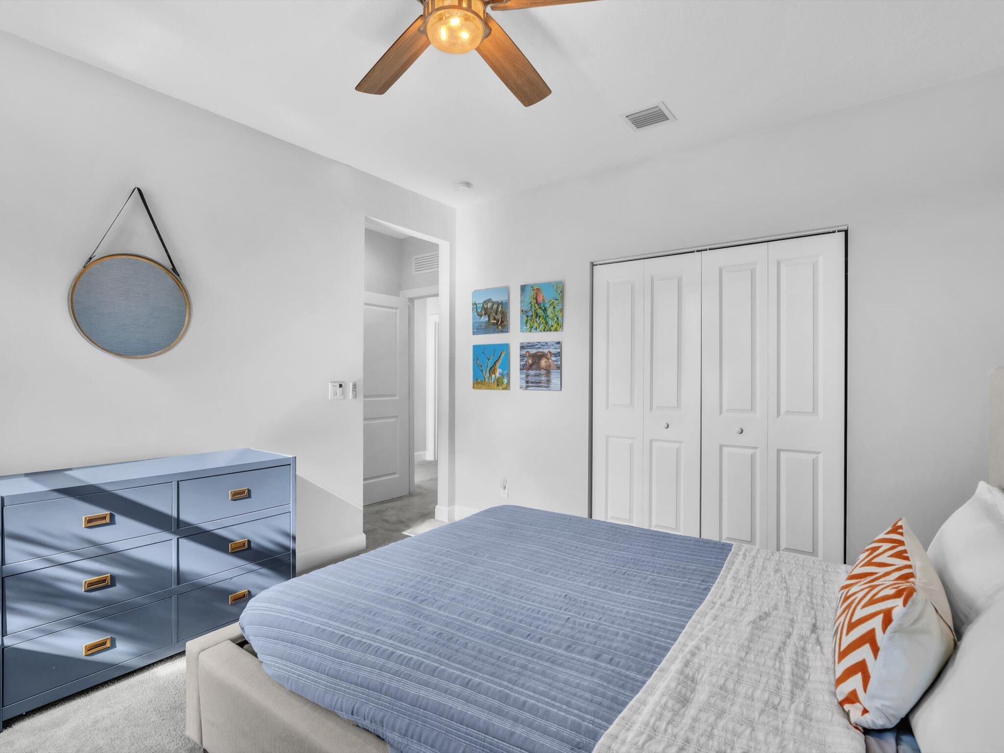 4708 Saddle Ranch Road Lake Worth, FL 33467 - Photo 18 of 45 a bedroom with a bed and a chandelier