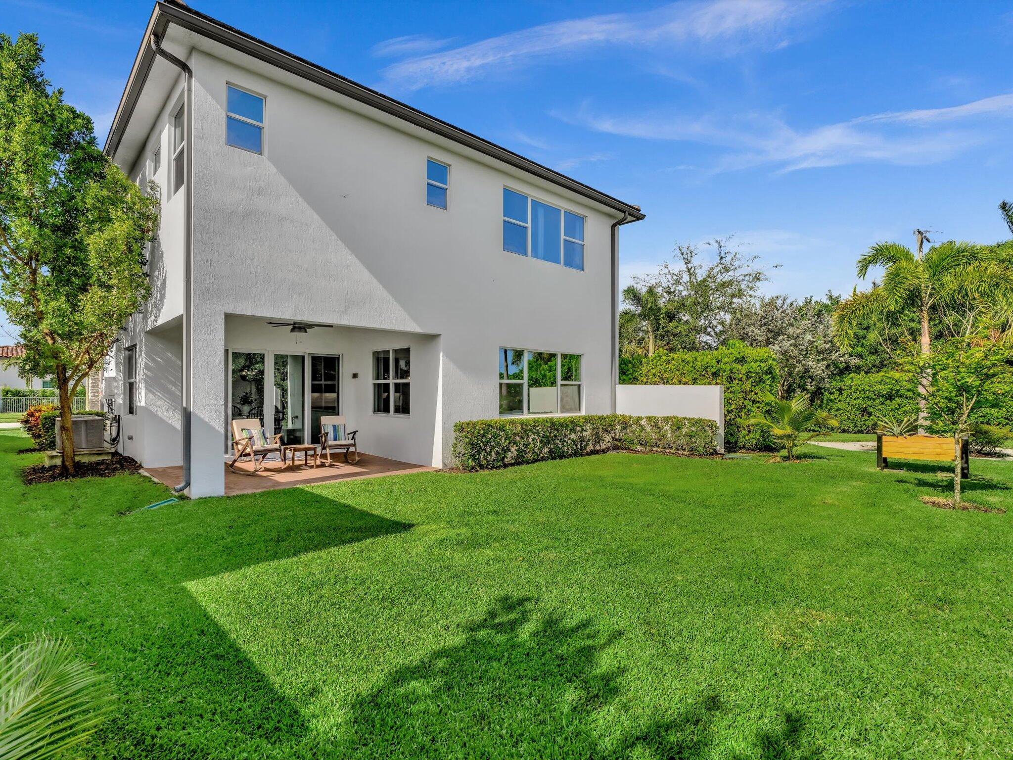 4708 Saddle Ranch Road Lake Worth, FL 33467 - Photo 33 of 45 a front view of a house with patio and garden
