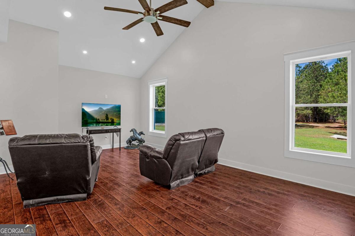328 Windsor Road Guyton, GA 31312 - Photo 15 of 39 a living room with furniture and a flat screen tv
