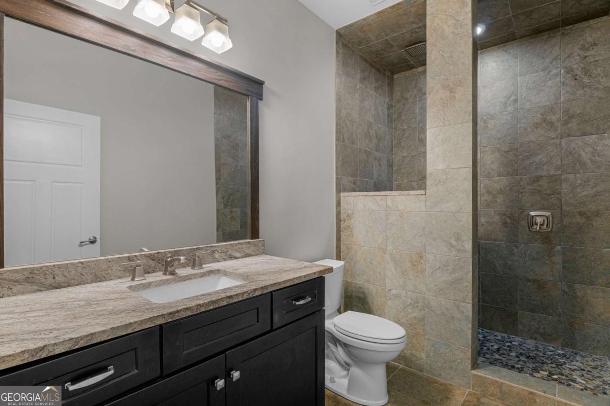 328 Windsor Road Guyton, GA 31312 - Photo 20 of 39 a bathroom with a granite countertop sink toilet and shower