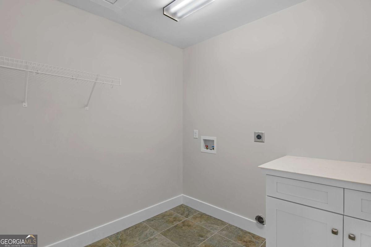 328 Windsor Road Guyton, GA 31312 - Photo 25 of 39 a bathroom with a white toilet and vanity