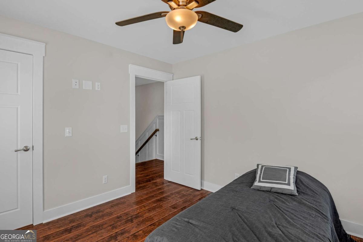 328 Windsor Road Guyton, GA 31312 - Photo 26 of 39 a view of a livingroom with a ceiling fan and wooden floor