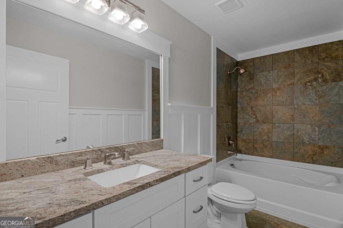 328 Windsor Road Guyton, GA 31312 - Photo 28 of 39 a bathroom with a granite countertop sink a toilet and shower